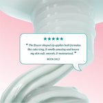 Review text reading “The flower‑shaped tip applies both formulas like cake icing. It smells amazing and leaves my skin soft, smooth, & moisturized.” credited to Moon Child.