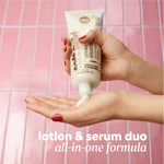 Product being dispensed from a Soft Skin Lotion & Serum Duo tube into an open hand against a pink tile background. Text reads ‘lotion & serum duo all‑in‑one formula.'
