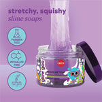 Purple slime soap being stretched upward from an open jar labeled with playful graphics, shown on a lavender background. Text highlights that the slime soap is stretchy and squishy, paraben‑free, and phthalate‑free.